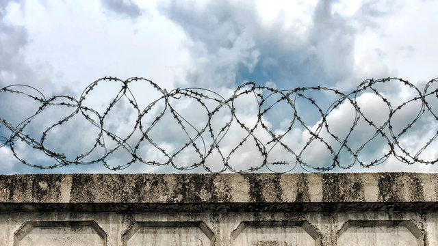 concrete wall with barbed wire