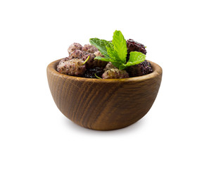 Mulberries in a wooden bowl with copy space for text. Black and purple mulberry on white...
