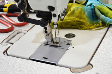Sewing machine on table in tailor's workshop