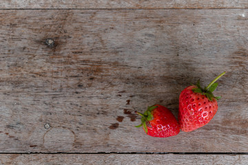 Strawberry on wooden floor.