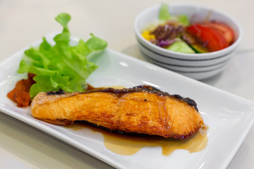 Grilled salmon in a white plate