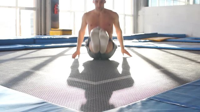 Fitness man jumping on small trampolines,exercise on rebounder. slow motion