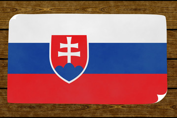 Fototapeta premium Illustration of a Slovakian flag on the paper pasted on the woody wall