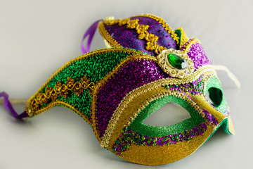 Jester mask with large gem.  Object only.  No people.  White background.