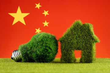 Green eco light bulb, eco house icon and China Flag. Renewable energy. Electricity prices, energy saving in the household.