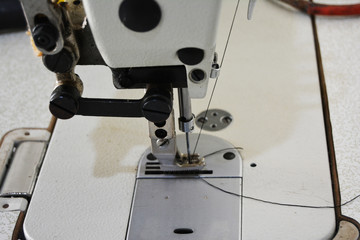 Sewing machine on table in tailor's workshop