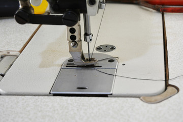Sewing machine on table in tailor's workshop