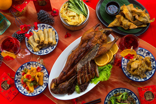 Chinese New Year Party Table In Red And Gold Theme With Food, Drinks And Decorations