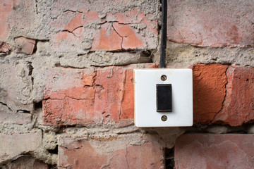 Old switcher on the brick wall with wire