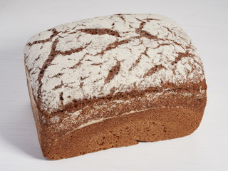 Loaf of rye bread on a light background