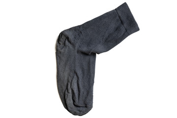 Old gray sock, isolated, close up. One worn used dirty sock after long wearing.