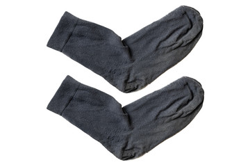 Old gray socks, isolated, close up. Two worn used dirty socks after long wearing.