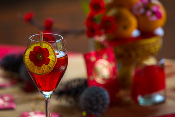 Chinese New Year party table in red and gold theme with food, drinks and decorations