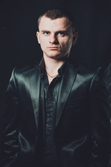 Fototapeta premium Strict male portrait The guy in the classic black suit.