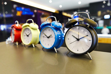 Retro alarm clock on the table in a row