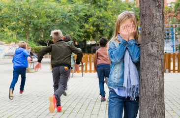 Kids playing hide and seek on the street