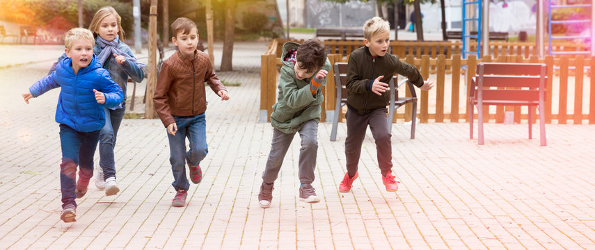 Smiling children playing romp game Touch-last