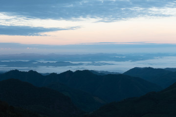 Silhouette mountain layers with sea of fog, sky, cloud and sunrise at Khun Yuam, Mae Hong Son, Thailand