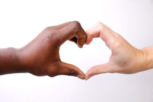 Hands make heart form, Valentines day and a picture with a message saying no to Discrimination