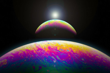 Eclipse of a soap bubble aligned with sun flare