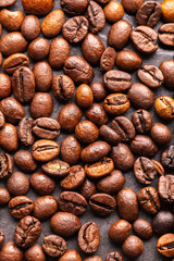 Roasted coffee beans on a dark slate for texture and background