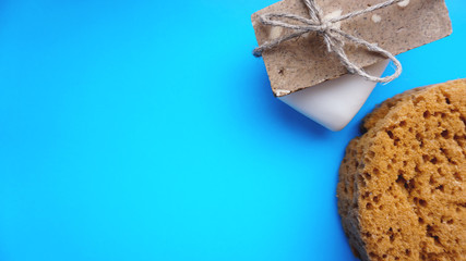 Handmade soap wrapped with twine on a blue clean background