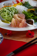 Chinese New Year party table in red and gold theme with food, drinks and decorations