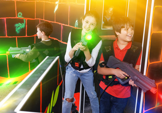 Kids playing laser tag on labyrinth