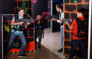 Kids playing laser tag on labyrinth