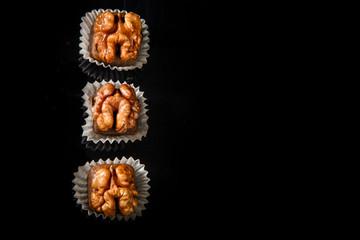 top view on three healthy useful organic handmade candies with walnut