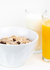 Balanced breakfast with muesli bowl, milk and fresh orange juice