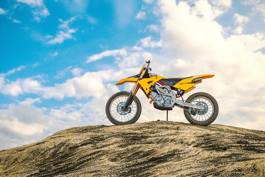 Yellow racing motorcycle on the motocross track. The off the road. 3d
