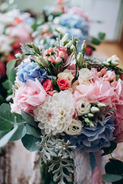 A Beautiful Wedding Bouquet From Blue, Red, White And Pink Flowers For The Bride. Wedding Details And A Natural Concept