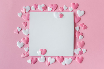 Valentines day concept. Greeting card with a pink and white hearts and space for text on a pink background. Top view. Flat lay.