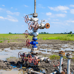 Oil well after repair in mud and puddles.