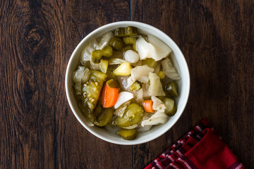 Mix of Turkish Pickles with Hot Green Pepper, Cabbage, Sauerkraut, Carrot and Cucumber in Bowl.