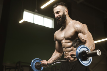 Handsome strong athletic men pumping up muscles workout barbell curl bodybuilding concept background