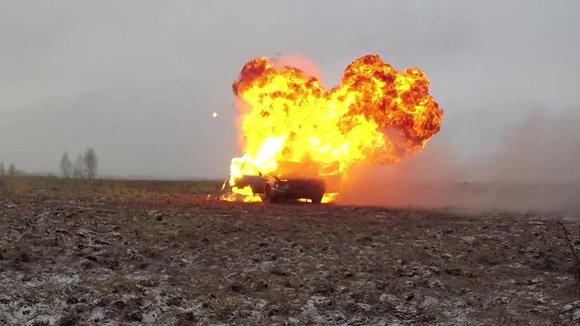 Car Explosion In Slow Motion, Car burns in a gray field