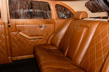 interior of the car is a brown color and leather