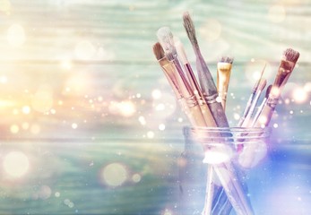 Row of artist paint brushes  on background