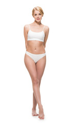 Obraz premium full length view of beautiful slim girl in underwear standing and looking at camera isolated on white
