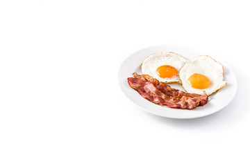 Fried eggs and bacon for breakfast isolated on white background. Copyspace

