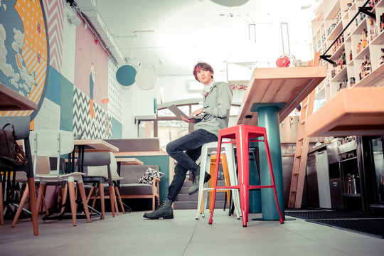 Teenager Working With The Laptop In The Cafe