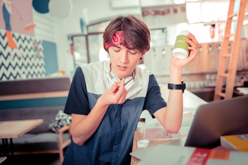 Teenager taking vitamin D pills while preparing for the exam