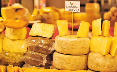 cheese laid out for sale on market stall