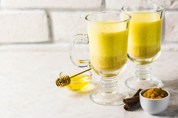 Golden milk with honey and cinnamon. Selective focus, space for text.