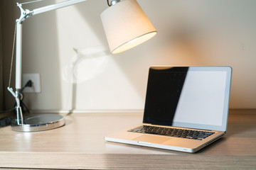 Laptop on a desk with lamp
