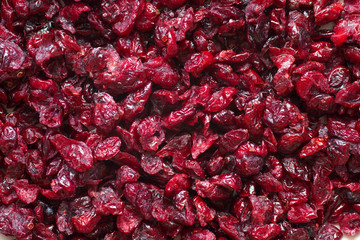 Delicious dried cranberries close-up in a wooden spoon. Organic food.