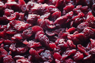 Delicious dried cranberries close-up in a wooden spoon. Organic food.
