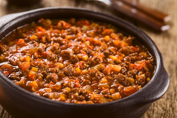 Homemade vegan bolognese sauce made with soy meat, fresh tomatoes, onion and garlic, served in rustic bowl (Selective Focus, Focus one third into the sauce) - obrazy, fototapety, plakaty